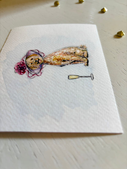 Fine art print with a decorative design of a Golden Doodle and a champagne glass on a light wooden surface.