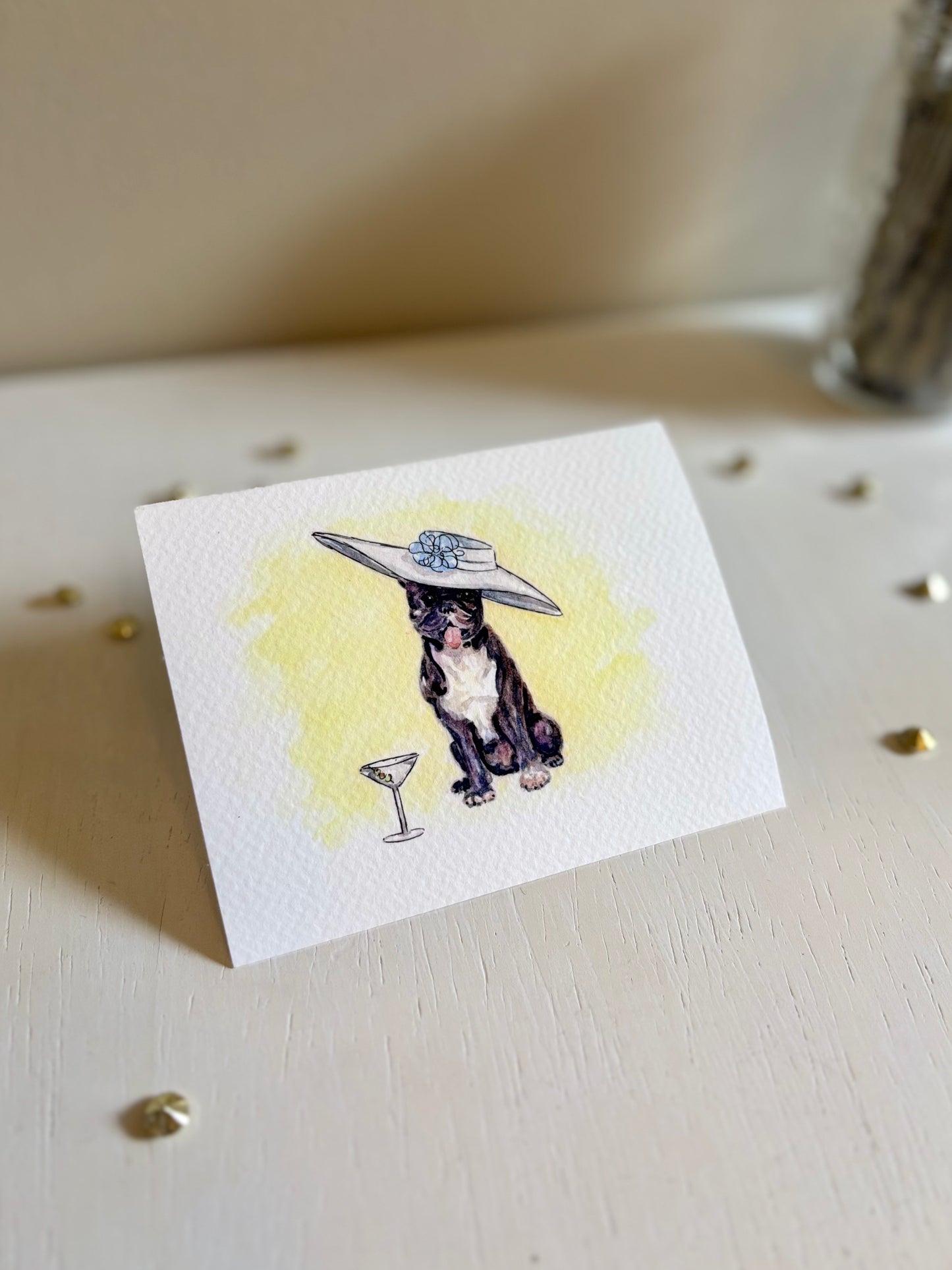 Miniature fine art print with a French Bulldog wearing a hat and a martini glass on a light surface.